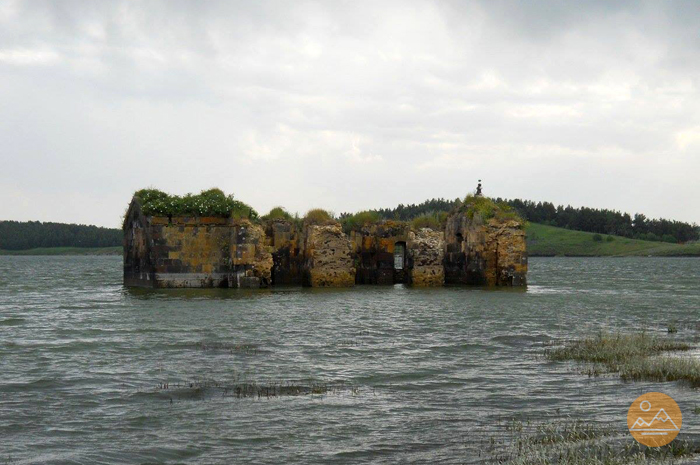 Ruins of Saint Paul and Peter church of Zovuni, Armenia half under waters of Aparan reservoir